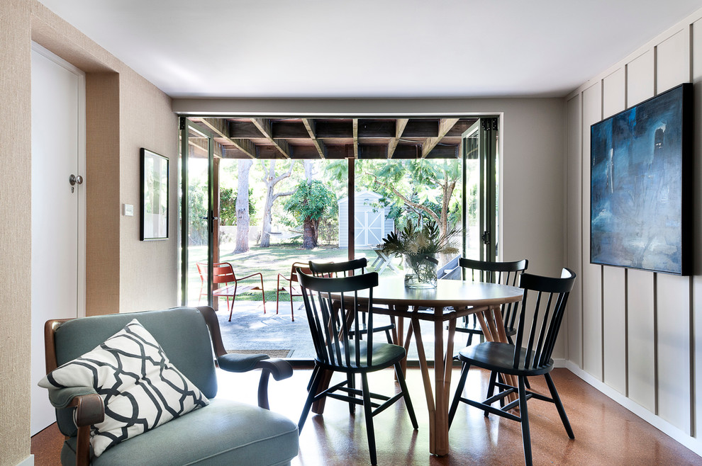 Photo of a beach style dining room in Sydney with beige walls and cork floors.