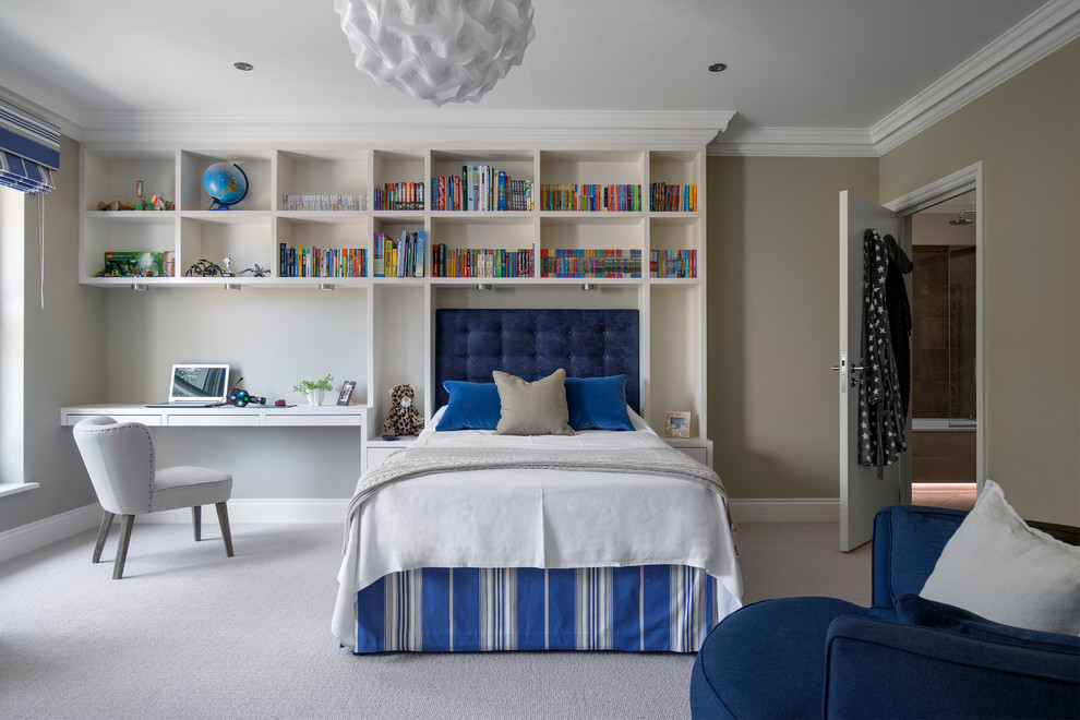 This is an example of a mid-sized transitional kids' bedroom for kids 4-10 years old and boys in Surrey with beige walls, carpet and grey floor.