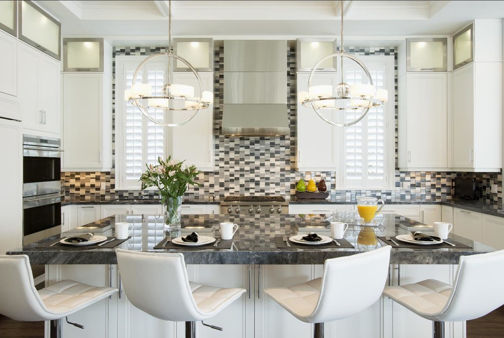 Inspiration for a mid-sized contemporary l-shaped dark wood floor eat-in kitchen remodel with flat-panel cabinets, white cabinets, granite countertops, gray backsplash, glass tile backsplash, stainless steel appliances and an island