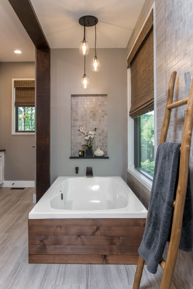 Mid-sized country master bathroom in Other with shaker cabinets, white cabinets, a freestanding tub, an alcove shower, a two-piece toilet, beige tile, mosaic tile, beige walls, porcelain floors, a trough sink, soapstone benchtops, beige floor and black benchtops.