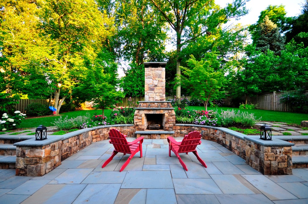 Large traditional backyard patio in DC Metro with natural stone pavers, a fire feature and no cover.