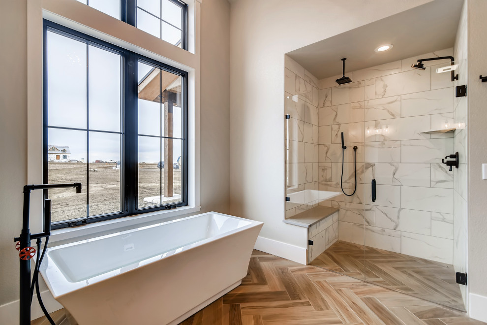 Photo of a large country master bathroom in Denver with shaker cabinets, white cabinets, a freestanding tub, a curbless shower, grey walls, porcelain floors, an undermount sink, quartzite benchtops, beige floor, a hinged shower door, grey benchtops, a shower seat, a double vanity, a built-in vanity, exposed beam, white tile and porcelain tile.