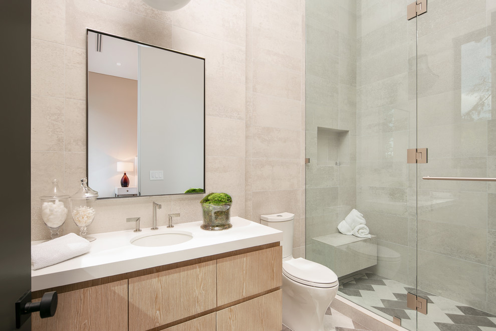 Inspiration for a large contemporary bathroom in Los Angeles with flat-panel cabinets, light wood cabinets, a one-piece toilet, gray tile, multi-coloured floor, a hinged shower door, an alcove shower, beige walls, an undermount sink and white benchtops.