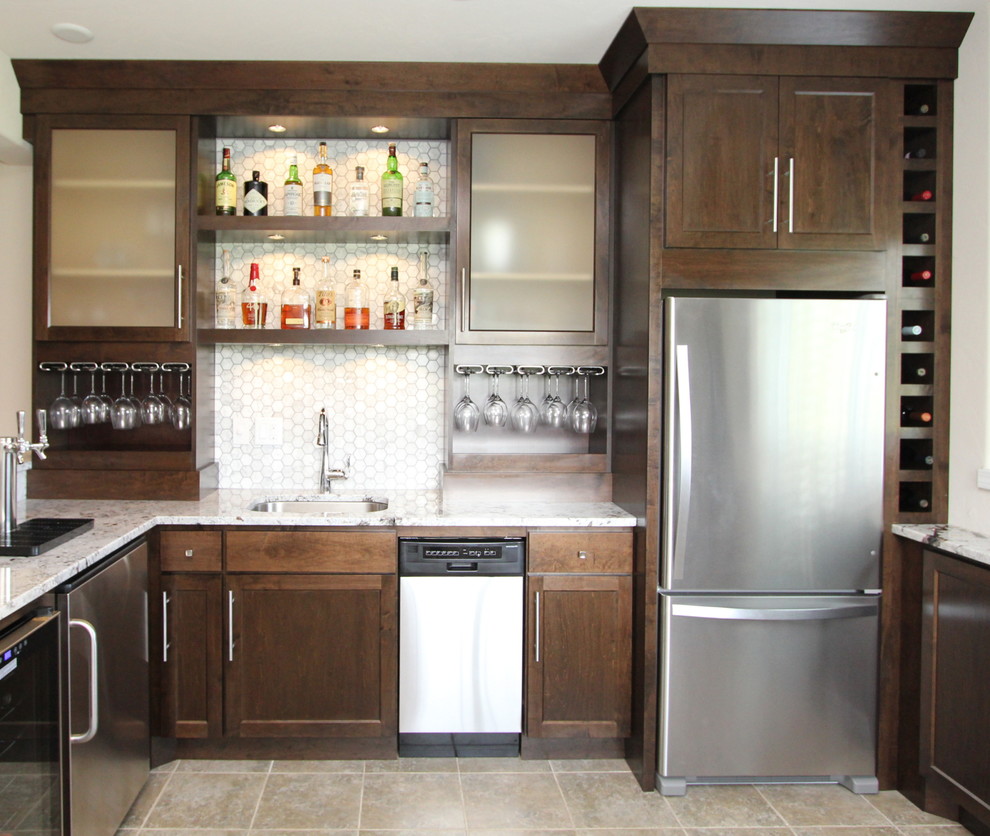 Mid-sized transitional u-shaped seated home bar in Milwaukee with an undermount sink, shaker cabinets, dark wood cabinets, granite benchtops, grey splashback, mosaic tile splashback, ceramic floors and brown floor.