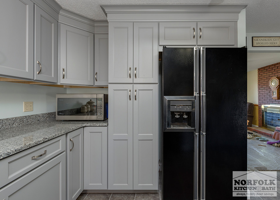 Home design - mid-sized transitional u-shaped home design idea in Boston with an undermount sink, shaker cabinets, gray cabinets, granite countertops, stainless steel appliances and no island