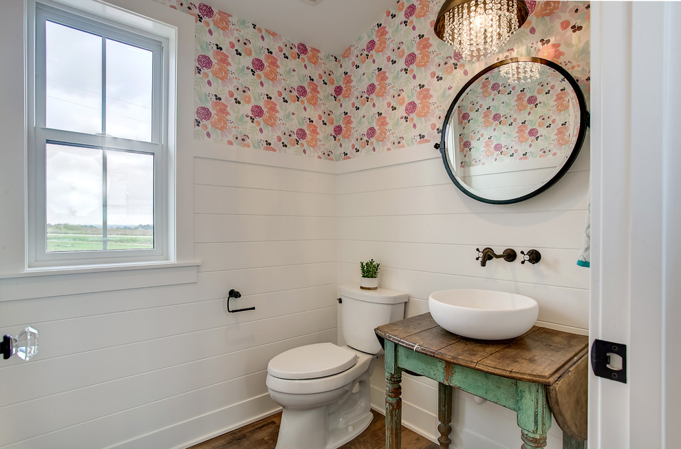 Inspiration for a country bathroom in Grand Rapids with open cabinets, distressed cabinets, multi-coloured walls, medium hardwood floors, a vessel sink, wood benchtops, brown floor and brown benchtops.