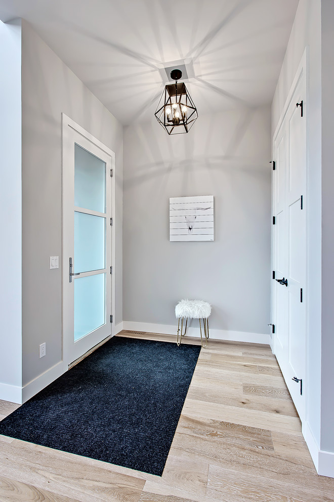 Transitional foyer in Calgary with grey walls, light hardwood floors, a single front door and a glass front door.