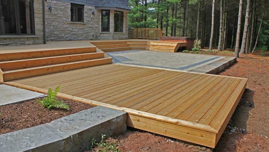 Inspiration for a large rustic backyard deck remodel in Toronto with no cover