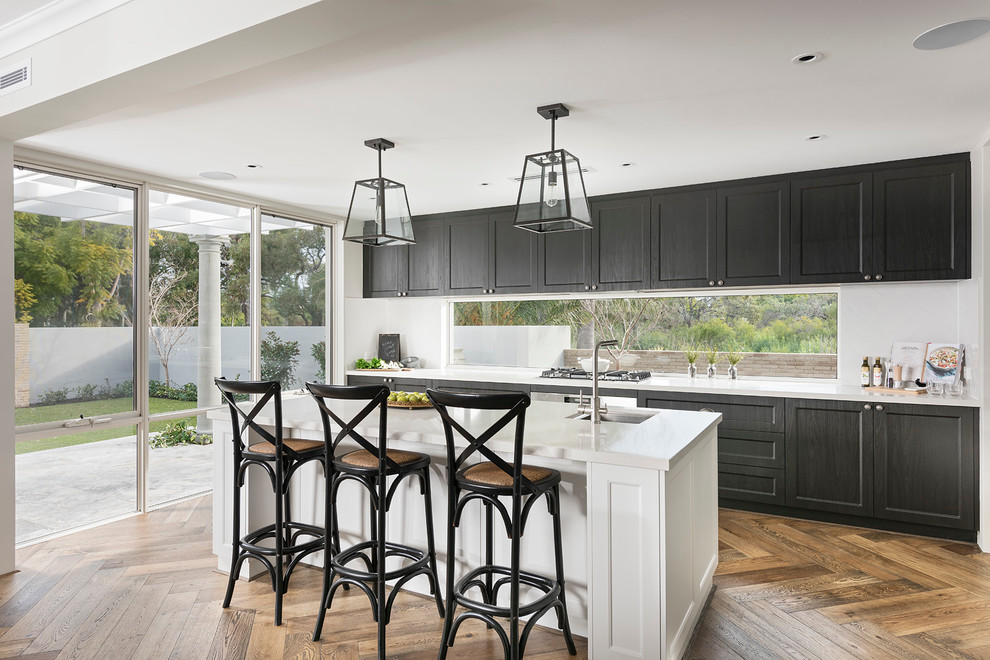 Large transitional galley eat-in kitchen in Perth with an undermount sink, black cabinets, white splashback, dark hardwood floors, with island and shaker cabinets.