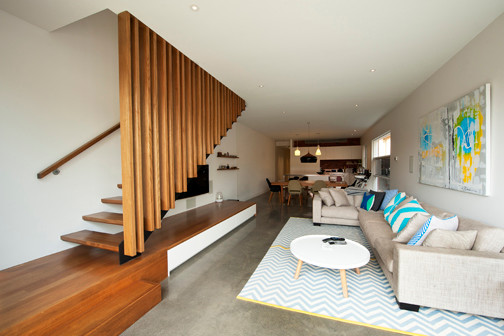 Photo of a mid-sized contemporary wood straight staircase in Melbourne with open risers.