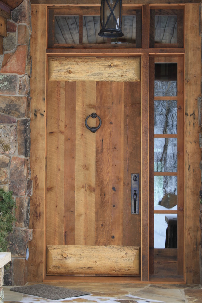 Photo of a mid-sized country front door in Denver with multi-coloured walls, slate floors, a single front door and a medium wood front door.