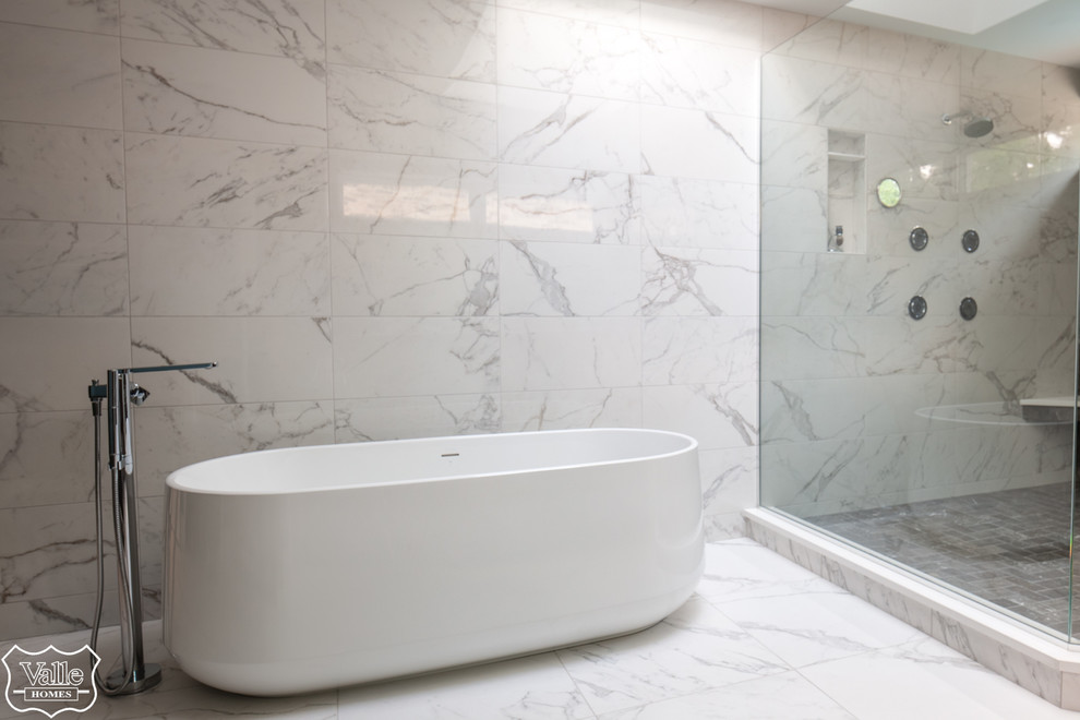 Large transitional master brown tile and ceramic tile porcelain tile and white floor freestanding bathtub photo with flat-panel cabinets, brown cabinets, a bidet, blue walls, an undermount sink, wood countertops, a hinged shower door and brown countertops