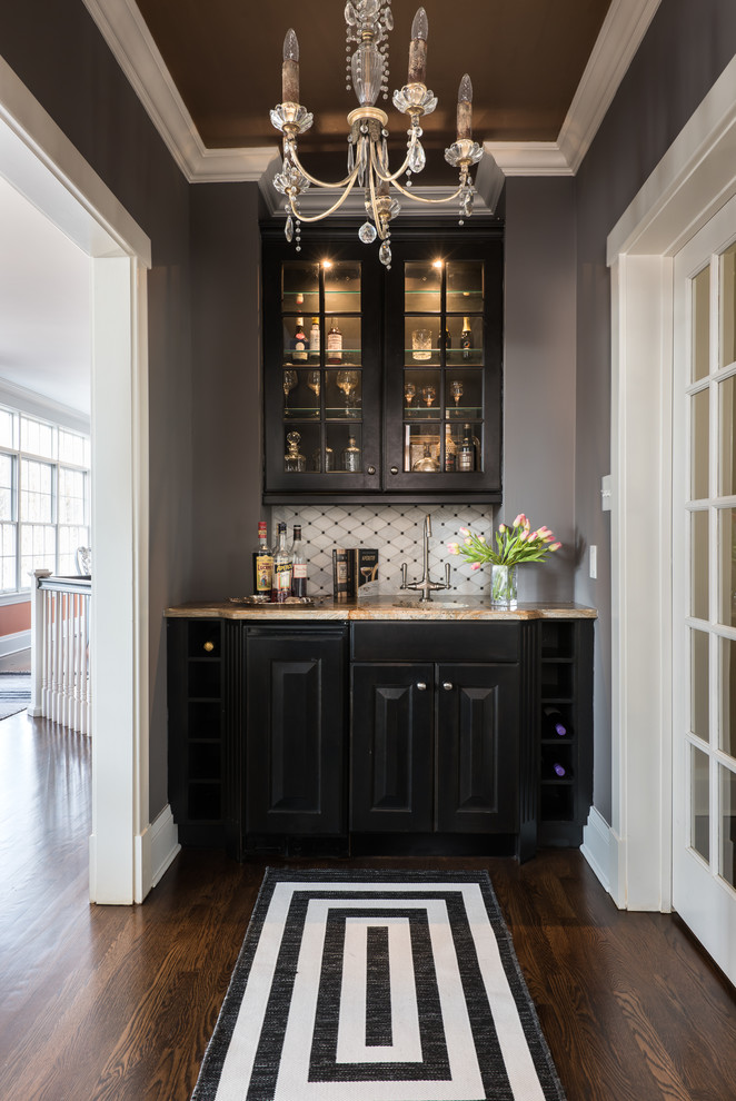 Design ideas for a small transitional single-wall wet bar in St Louis with an undermount sink, raised-panel cabinets, black cabinets, granite benchtops, brown floor, dark hardwood floors and beige benchtop.