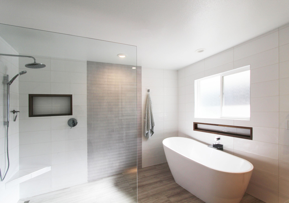 Example of a large transitional master white tile and ceramic tile porcelain tile, gray floor and double-sink freestanding bathtub design with flat-panel cabinets, dark wood cabinets, a one-piece toilet, white walls, an undermount sink, quartz countertops, gray countertops, a niche and a floating vanity