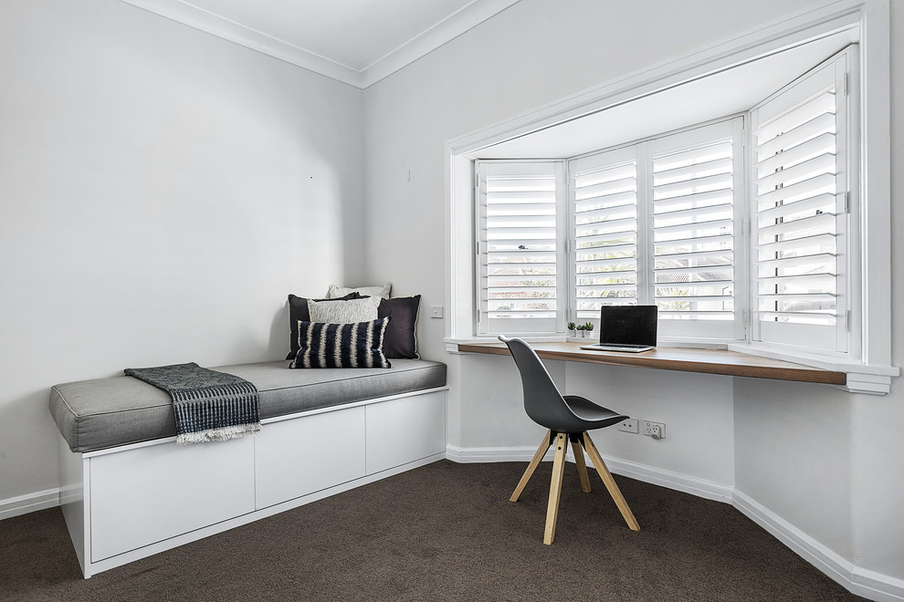 Mid-sized contemporary home office in Sydney with white walls, carpet and black floor.