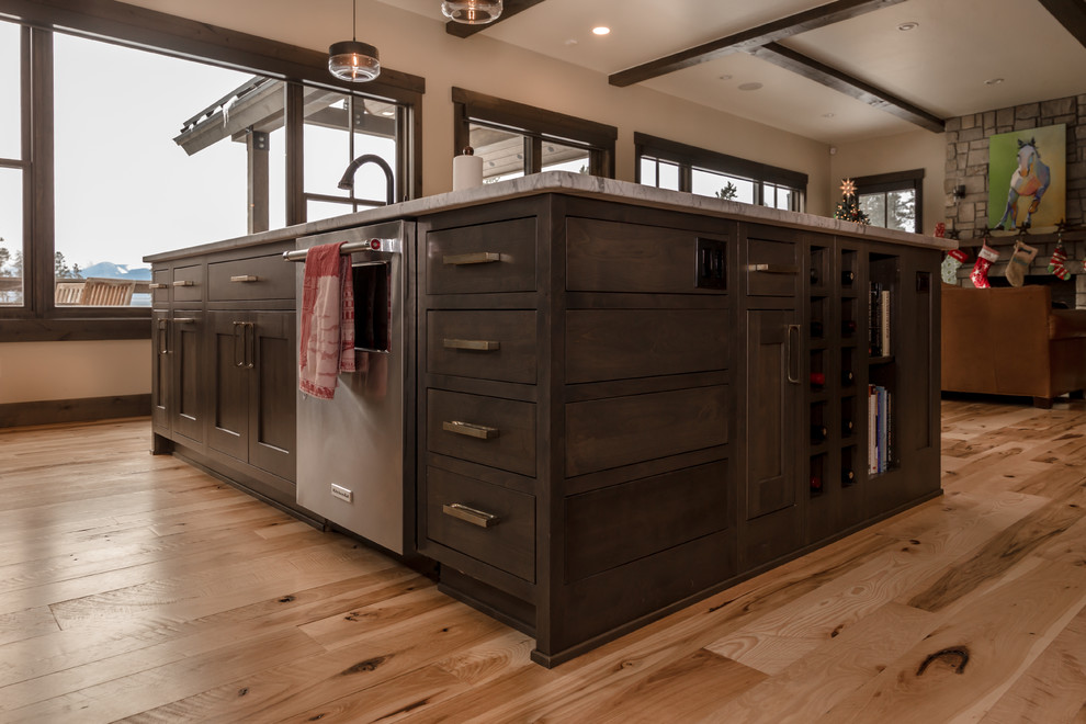 Open concept kitchen - large rustic l-shaped light wood floor and beige floor open concept kitchen idea in Denver with an undermount sink, shaker cabinets, dark wood cabinets, quartz countertops, beige backsplash, subway tile backsplash, stainless steel appliances, an island and white countertops