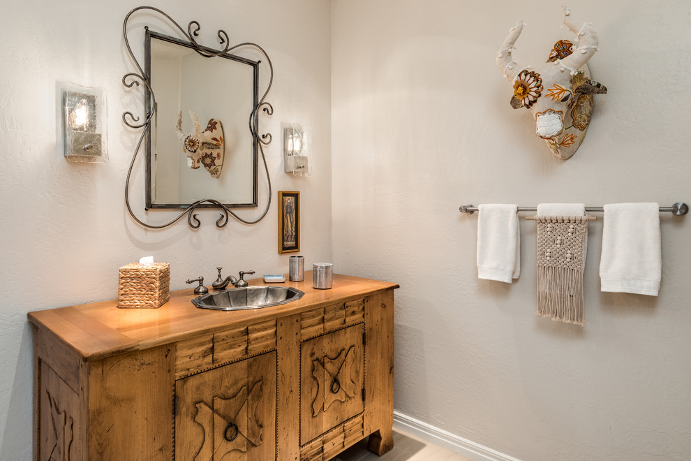 This is an example of an eclectic powder room in Phoenix.