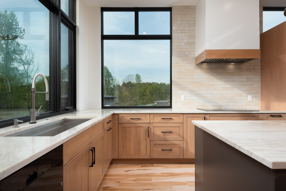 Inspiration for a mid-sized transitional u-shaped light wood floor eat-in kitchen remodel with an undermount sink, shaker cabinets, light wood cabinets, quartzite countertops, beige backsplash, subway tile backsplash, stainless steel appliances, an island and white countertops