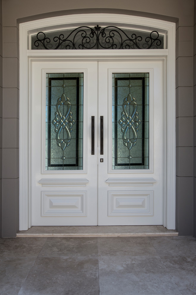 This is an example of a mid-sized traditional front door in Sydney with grey walls, marble floors, a double front door and a white front door.