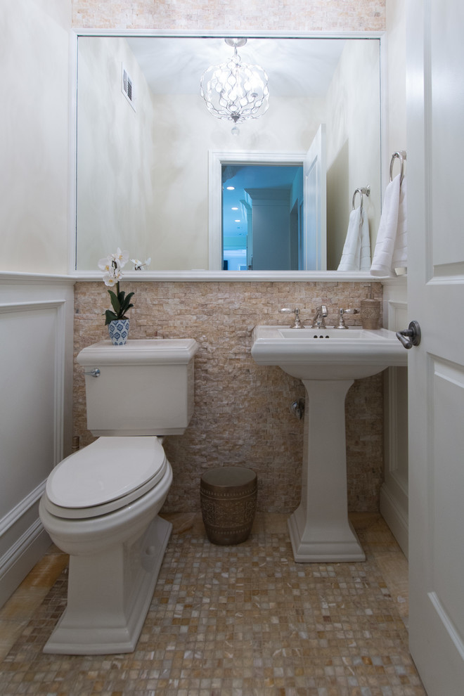 Photo of a small transitional powder room in New York with a two-piece toilet, beige tile, gray tile, white tile, stone tile, white walls, mosaic tile floors, a pedestal sink and multi-coloured floor.