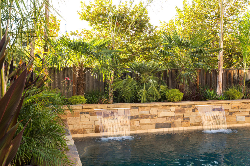 Design ideas for a large mediterranean backyard round pool in San Francisco with a hot tub and natural stone pavers.