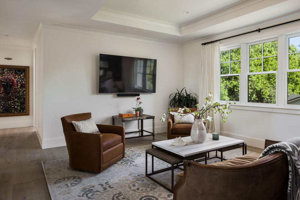 Inspiration for a large transitional open concept family room in San Francisco with white walls, medium hardwood floors, a wall-mounted tv, grey floor and coffered.
