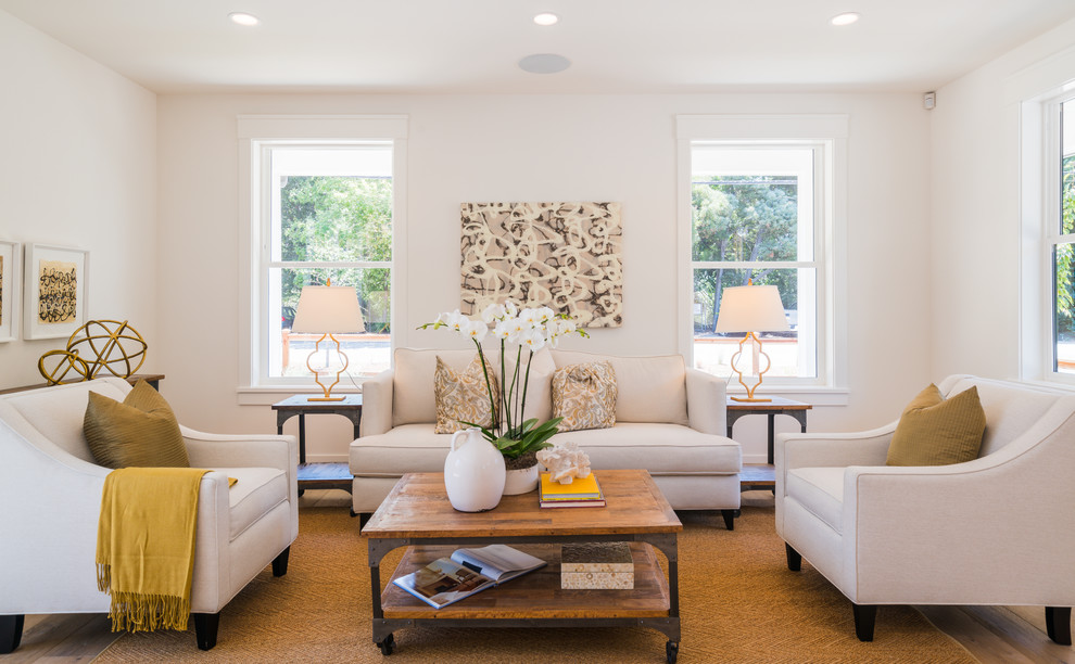 This is an example of a large transitional formal open concept living room in San Francisco with white walls, medium hardwood floors, no fireplace, no tv and brown floor.