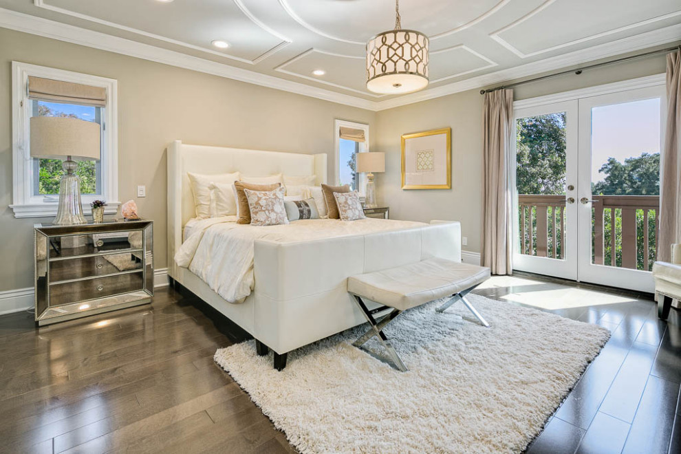 Photo of a large transitional master bedroom in Los Angeles with beige walls, dark hardwood floors, no fireplace and brown floor.