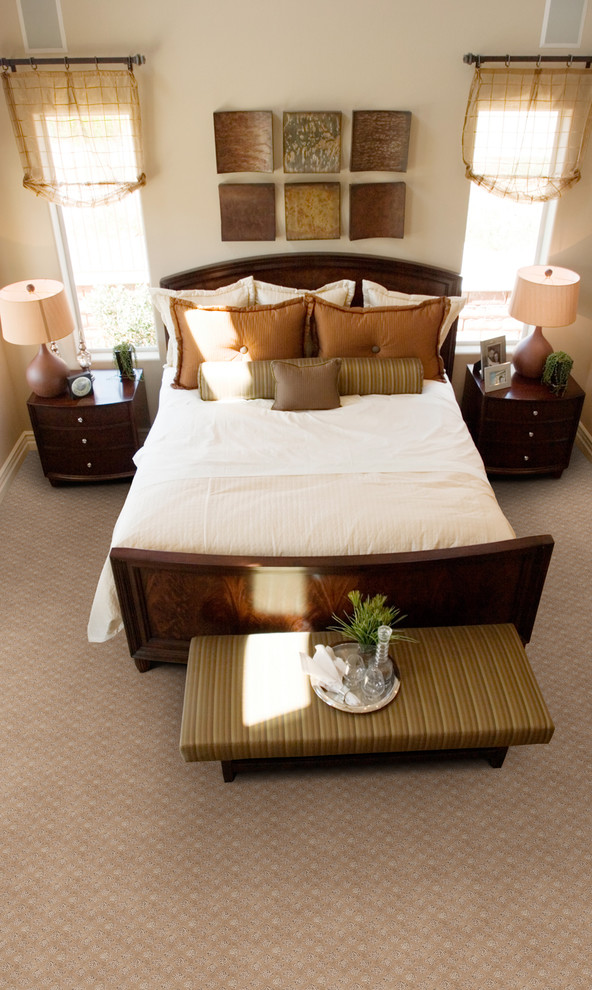 Photo of a large traditional master bedroom in Other with beige walls and carpet.