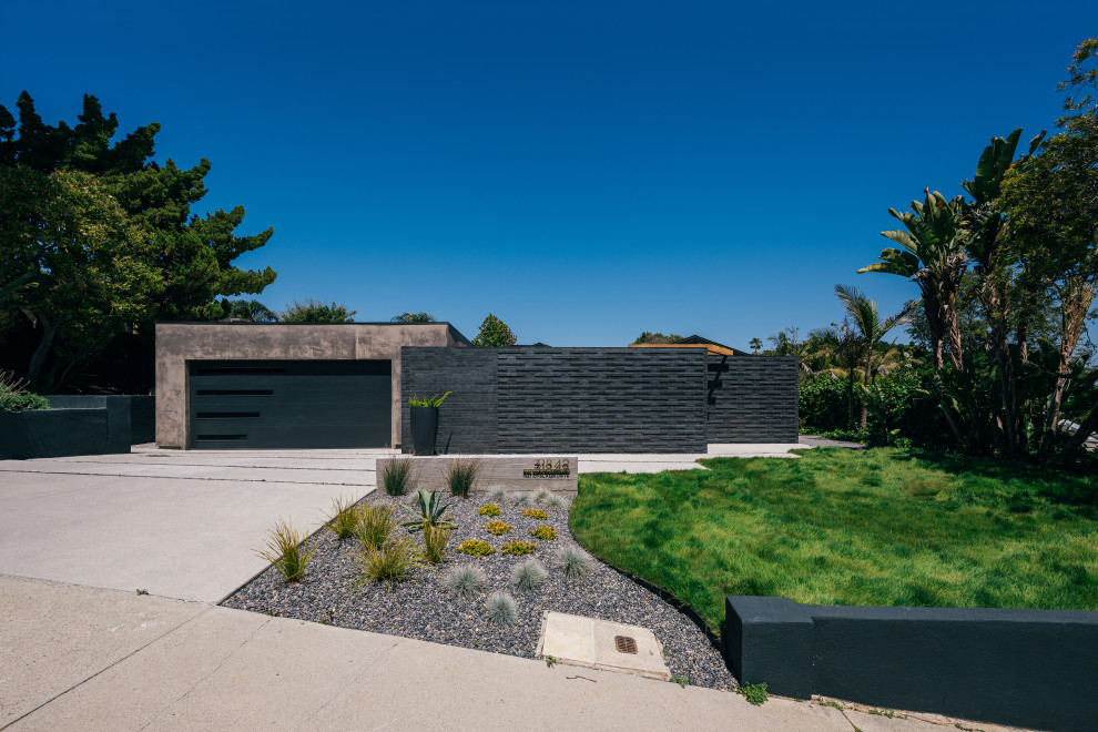 Ispirazione per la villa nera moderna a un piano di medie dimensioni con rivestimento in stucco, tetto piano e copertura mista