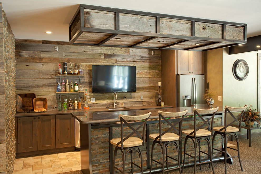 This is an example of a country galley seated home bar in Minneapolis with carpet, an undermount sink, shaker cabinets, dark wood cabinets and beige floor.