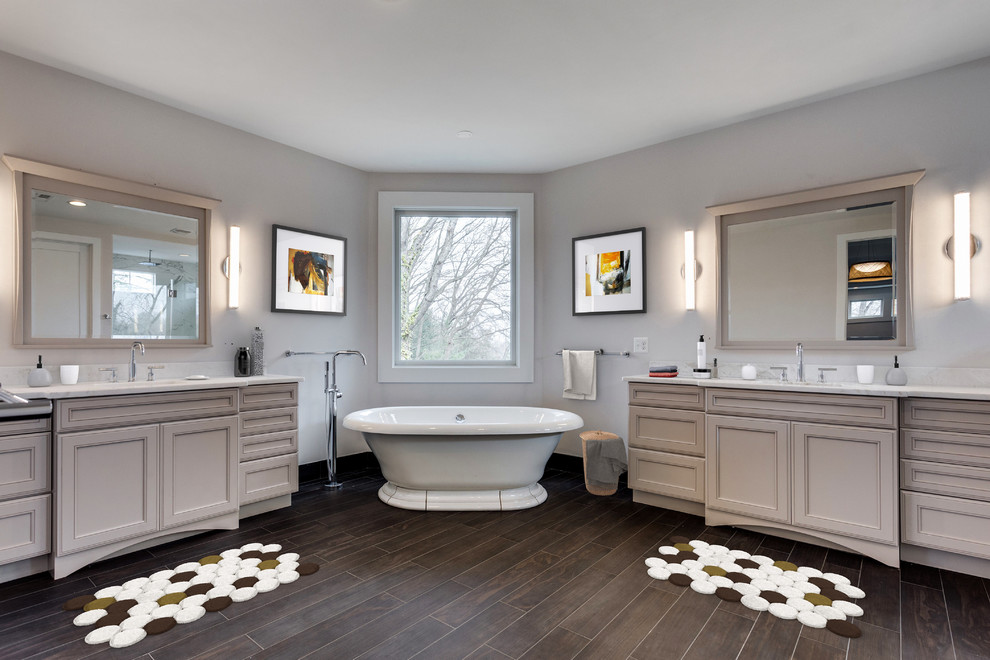 Example of a large transitional master porcelain tile and multicolored floor freestanding bathtub design in DC Metro with shaker cabinets, an undermount sink and a hinged shower door