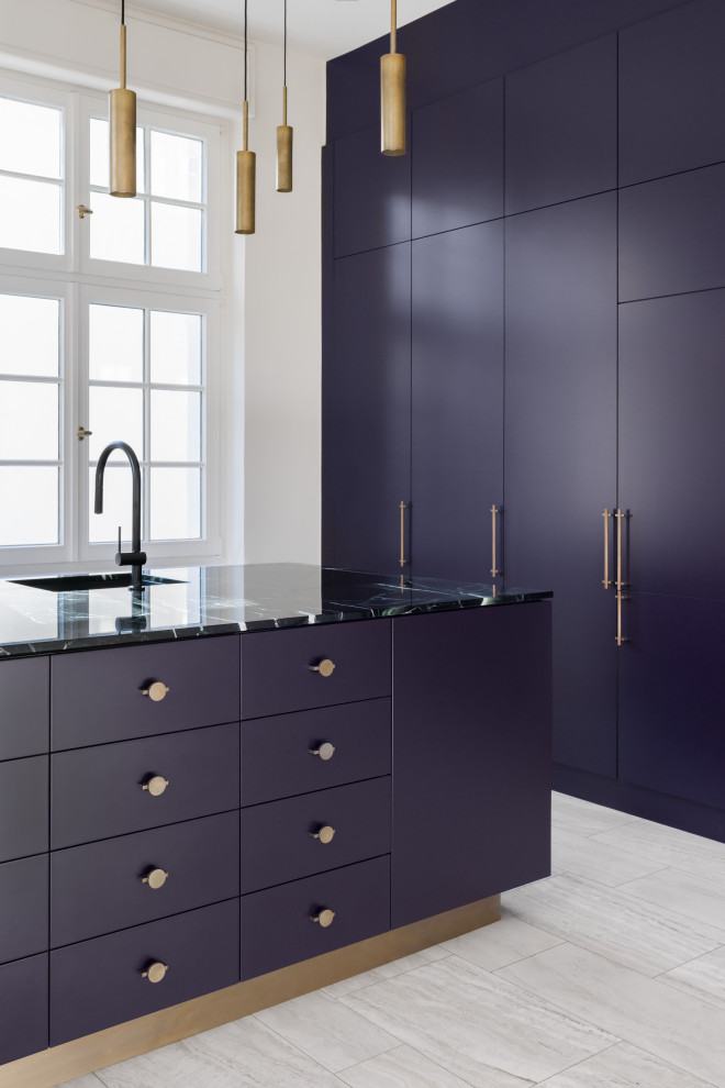 This is an example of an expansive contemporary single-wall open plan kitchen in Cologne with an undermount sink, flat-panel cabinets, purple cabinets, marble benchtops, with island and green benchtop.