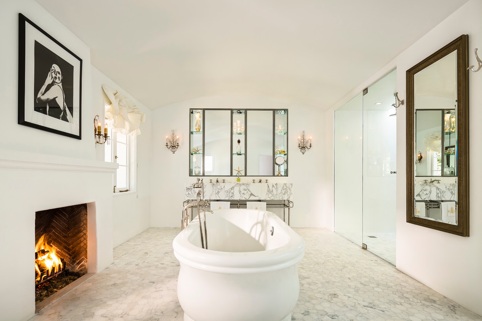 Inspiration for a large mediterranean master bathroom in Santa Barbara with a freestanding tub, white walls, marble floors and a curbless shower.