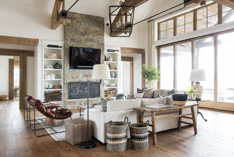 This is an example of a large transitional open concept family room in Salt Lake City with white walls, medium hardwood floors, a two-sided fireplace, a stone fireplace surround, a wall-mounted tv and brown floor.