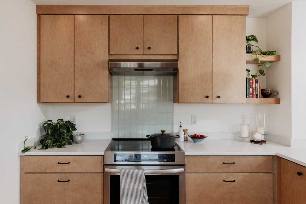 Kitchen pantry - mid-sized mid-century modern l-shaped medium tone wood floor kitchen pantry idea in Detroit with an undermount sink, flat-panel cabinets, light wood cabinets, quartz countertops, white backsplash, quartz backsplash, stainless steel appliances, a peninsula and white countertops