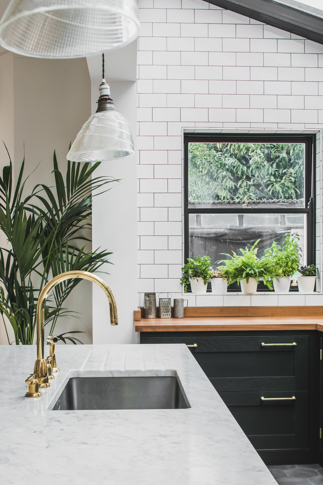 Inspiration for a large industrial galley eat-in kitchen in Other with an undermount sink, shaker cabinets, green cabinets, wood benchtops, white splashback, subway tile splashback, cement tiles, with island and grey floor.