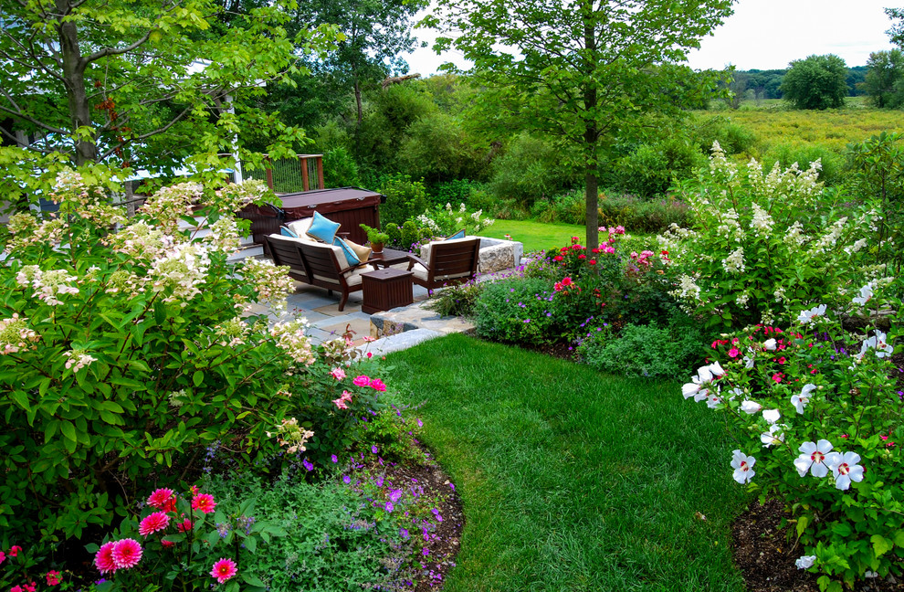 Design ideas for a mid-sized country backyard full sun garden in Boston with natural stone pavers and with flowerbed.