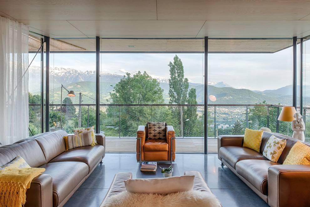 This is an example of a mid-sized contemporary formal open concept living room in Grenoble with concrete floors, no fireplace, no tv and grey floor.
