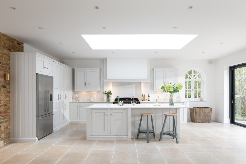 Photo of a large traditional l-shaped open plan kitchen in London with shaker cabinets, grey cabinets and an island.