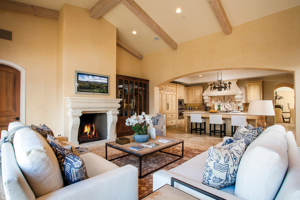 Country open concept family room in Orange County with pink walls, limestone floors, a standard fireplace, a concrete fireplace surround and a built-in media wall.