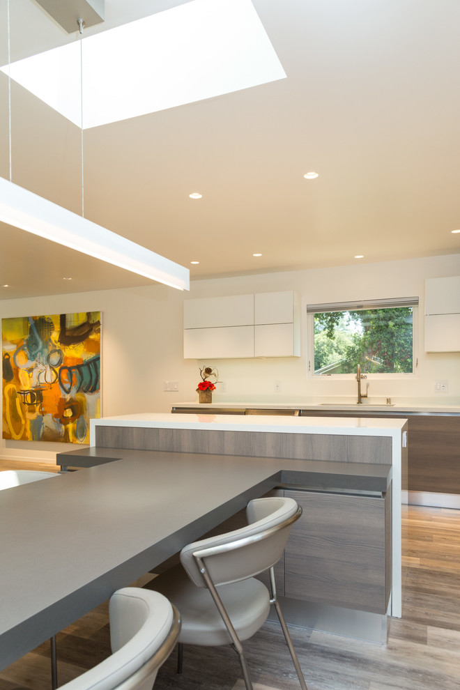 Photo of a large modern l-shaped eat-in kitchen in Other with quartz benchtops and multiple islands.