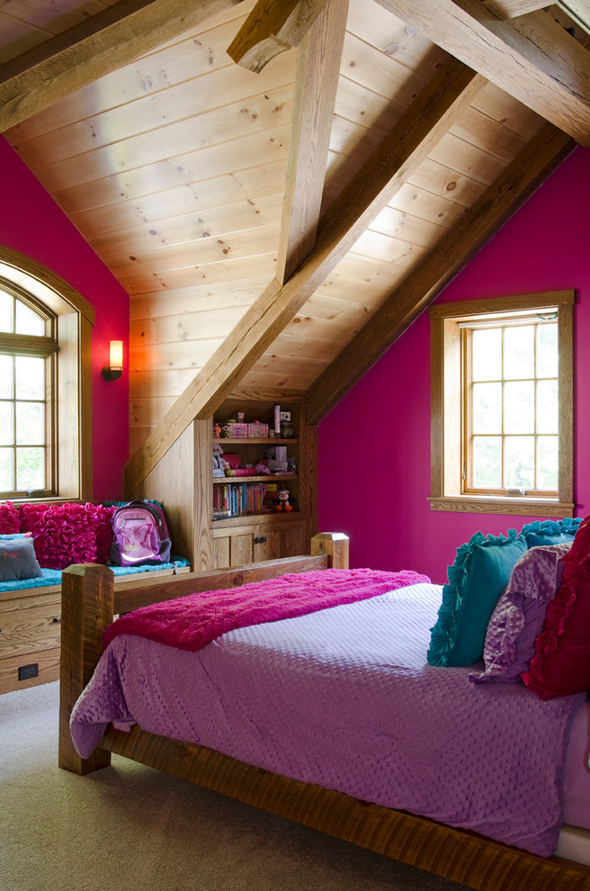This is an example of a mid-sized traditional loft-style bedroom in Boston with pink walls.
