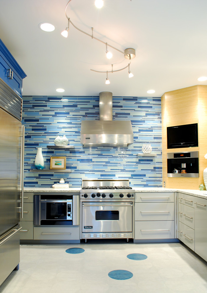 Contemporary kitchen in Austin with stainless steel appliances, blue splashback and matchstick tile splashback.
