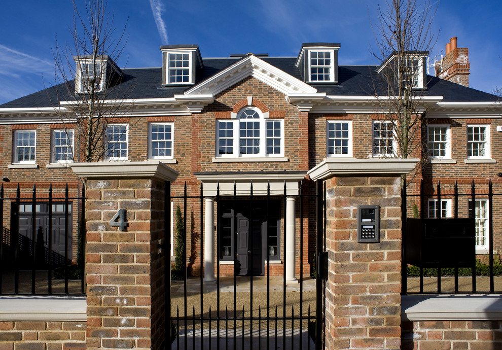 Inspiration for a classic brick house exterior in London with three floors.