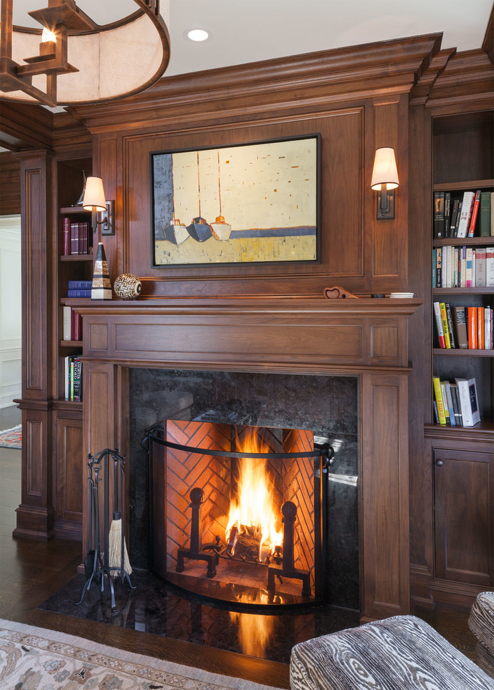 Large transitional study room in Boston with brown walls, dark hardwood floors, a standard fireplace, a built-in desk and a stone fireplace surround.