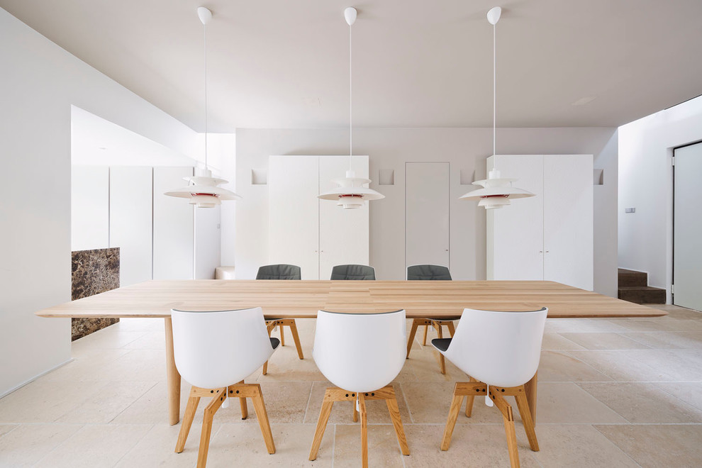 Photo of a scandinavian dining room in Milan with white walls.
