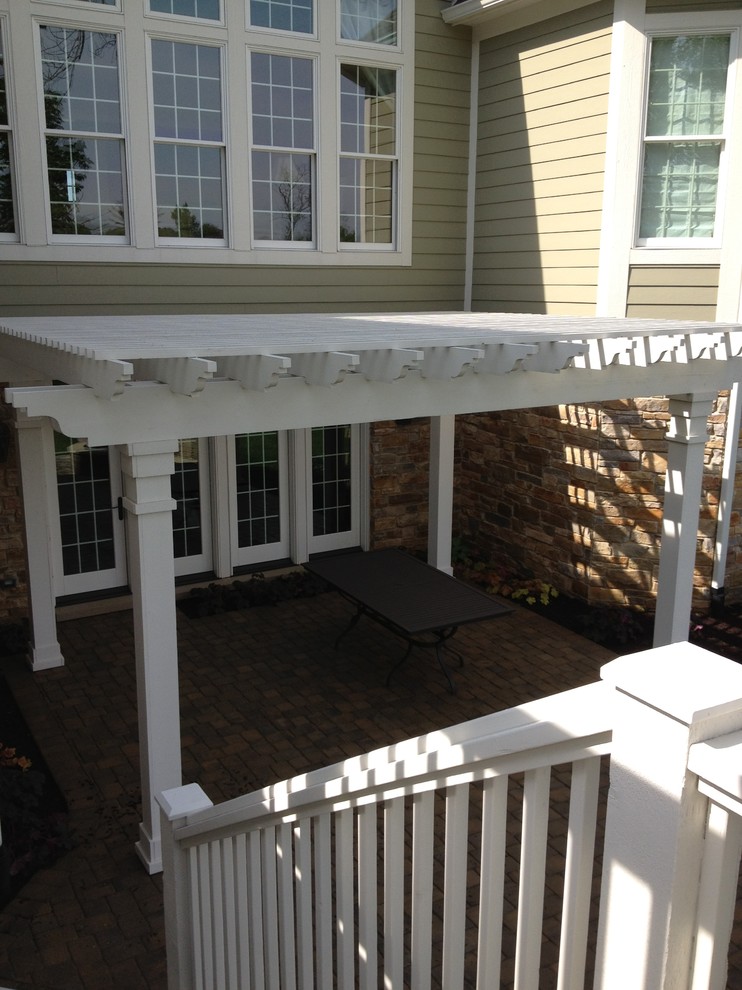 Mid-sized arts and crafts backyard deck in Indianapolis with a pergola.