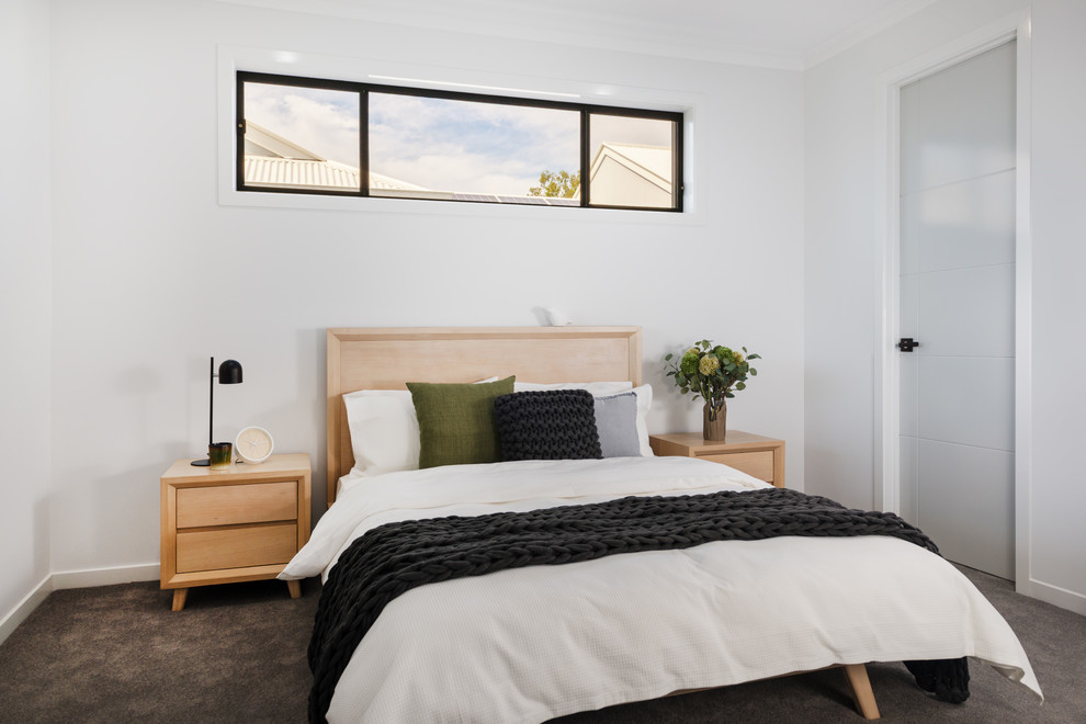 Contemporary bedroom in Brisbane with white walls, carpet and grey floor.