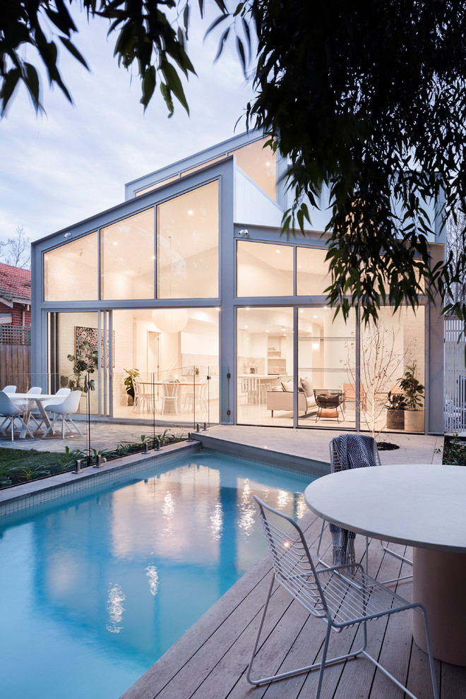 Photo of a mid-sized contemporary backyard rectangular pool in Melbourne with decking.